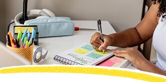 A student making notes on Post-it® Notes
