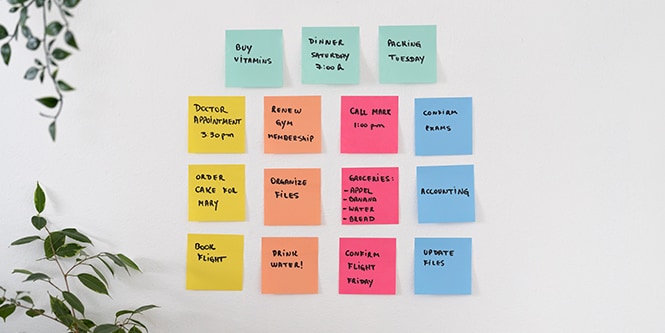 A wall full of colourful Post-it&reg; Notes with handwritten reminders
