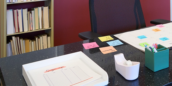 Task list on Post-it® Notes visible on the desk

