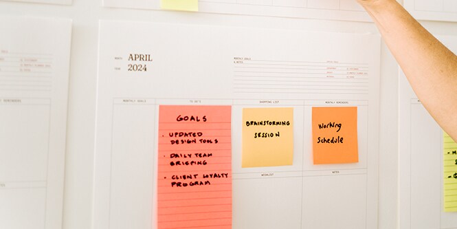 A calendar with Post-it® Notes highlighting goals and tasks
